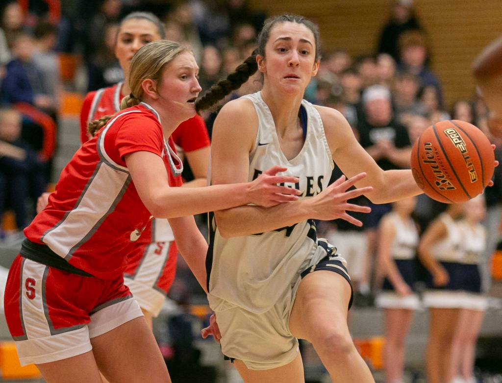 Arlington’s Jenna Villa tries to maneuver around a defender during the game against Stanwood on Saturday, Feb. 18, 2023 in Everett, Washington. (Olivia Vanni / The Herald)