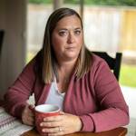 Marie Riley, 42, sits in her dining room with a cup of tea on Oct. 25, at her familys home in North Bend. Riley was born with tetralogy of fallot, a rare congenital heart condition that has required multiple open-heart surgeries during her lifetime. (Ryan Berry / The Herald)