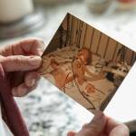 Marie Riley, 42, holds an image of herself as a child after an open-heart surgery on Oct. 25, at her familys home in North Bend. Riley was born with tetralogy of fallot, a rare congenital heart condition that has required multiple surgeries during her lifetime. (Ryan Berry / The Herald)