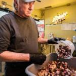 Jeff Knoch, owner of Jeff's Texas Style BBQ, pours brisket into his signature brisket baked beans on Thursday, Jan. 13, 2022 in Marysville, Washington. (Olivia Vanni / The Herald)