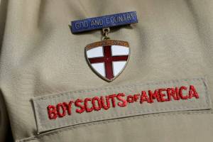 FILE - A close up of a Boy Scout uniform is photographed on Feb. 4, 2013, in Irving, Texas. A Delaware bankruptcy judge has approved a $2.46 billion reorganization plan Thursday, Sept. 8, 2022, proposed by the Boy Scouts of America that would allow it to continue operating while compensating tens of thousands of men who say were sexually abused as children while involved in Scouting. (AP Photo/Tony Gutierrez, File)