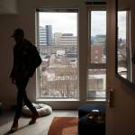 Property manager Dynasty Williams walks through a studio apartment at the Nimbus Apartments on Wednesday in downtown Everett. (Ryan Berry / The Herald)