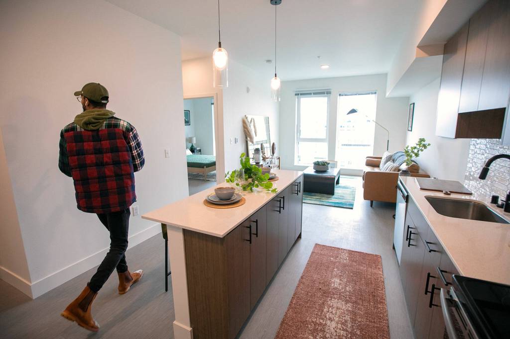 Property manager Dynasty Williams walks through a one-bedroom unit at the Nimbus Apartments. (Ryan Berry / The Herald)
