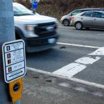 A truck passes over two small potholes at the intersection of Highway 9 and 64th Street NE on Thursday near Walmart in Marysville. (Ryan Berry / The Herald)