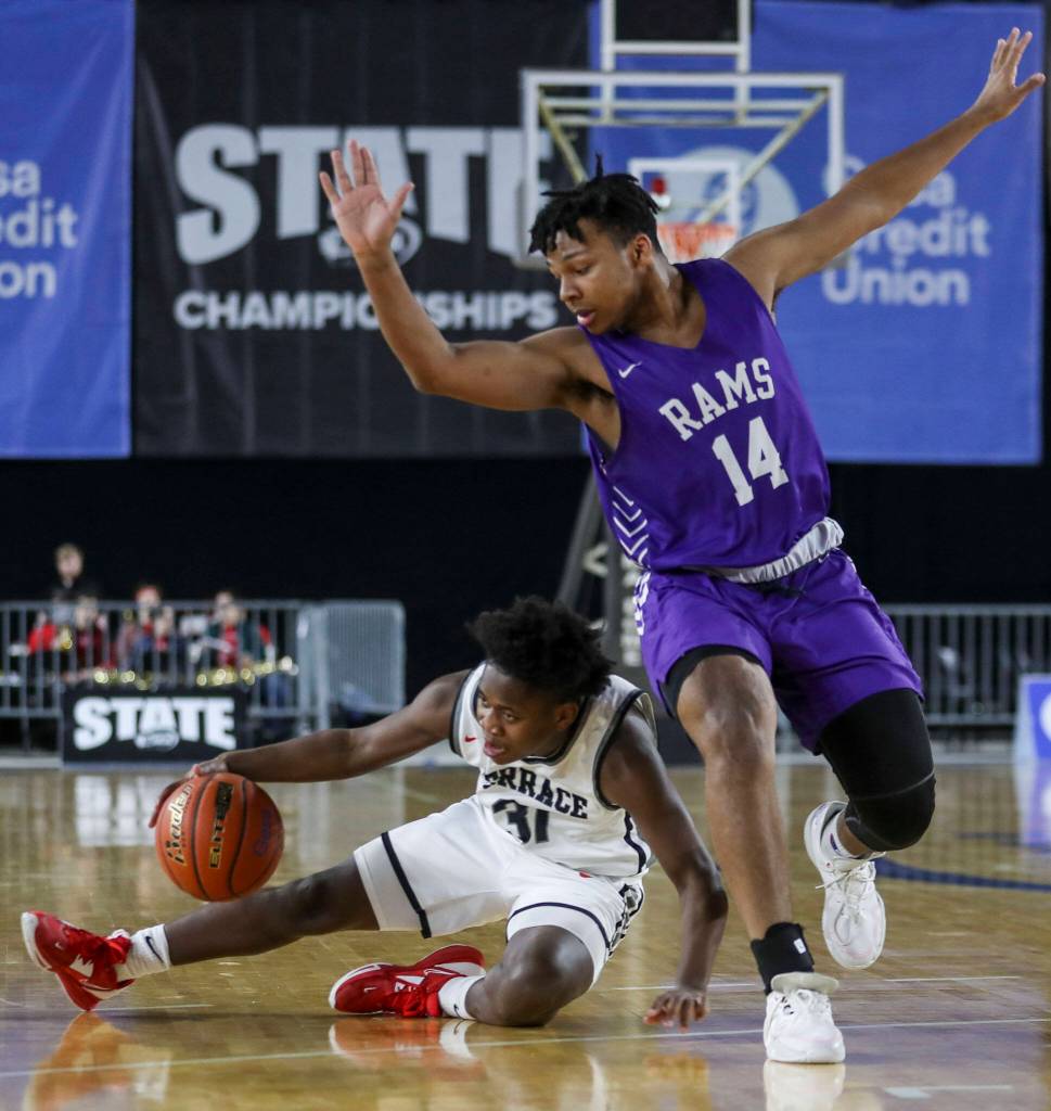 Mountlake Terraces Rayshaun Connor (31) fights for the ball with North Thurstons Ahmari Steplight (14) during a 3A boys game in the Hardwood Classic between Mountlake Terrace and North Thurston at the Tacoma Dome in Tacoma, Washington on Wednesday, March 1, 2023. Mountlake Terrace won, 58-53. (Annie Barker / The Herald)