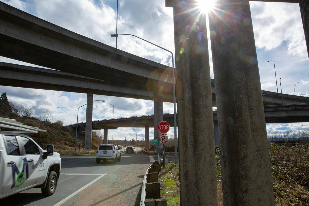 Drivers heading south Monday exit Highway 204 and pass under U.S. 2 in Lake Stevens. Cyclists attempting to follow U.S. 2 eastbound are directed by a sign to a short path that goes under an overpass before reaching the shoulder of the highway. (Ryan Berry / The Herald)