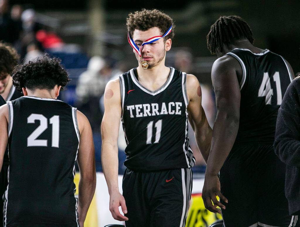 Mountlakes Chris Meegans sportsmanship medal hangs over his face as his team packs up after losing to ODea in the 3A quarterfinal game on Thursday, March 2, 2023 in Tacoma, Washington. (Olivia Vanni / The Herald)
