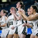 The Arlington bench reacts to a three-point shot during the 3A quarterfinal game against Meadowdale on Thursday, March 2, 2023 in Tacoma, Washington. (Olivia Vanni / The Herald)