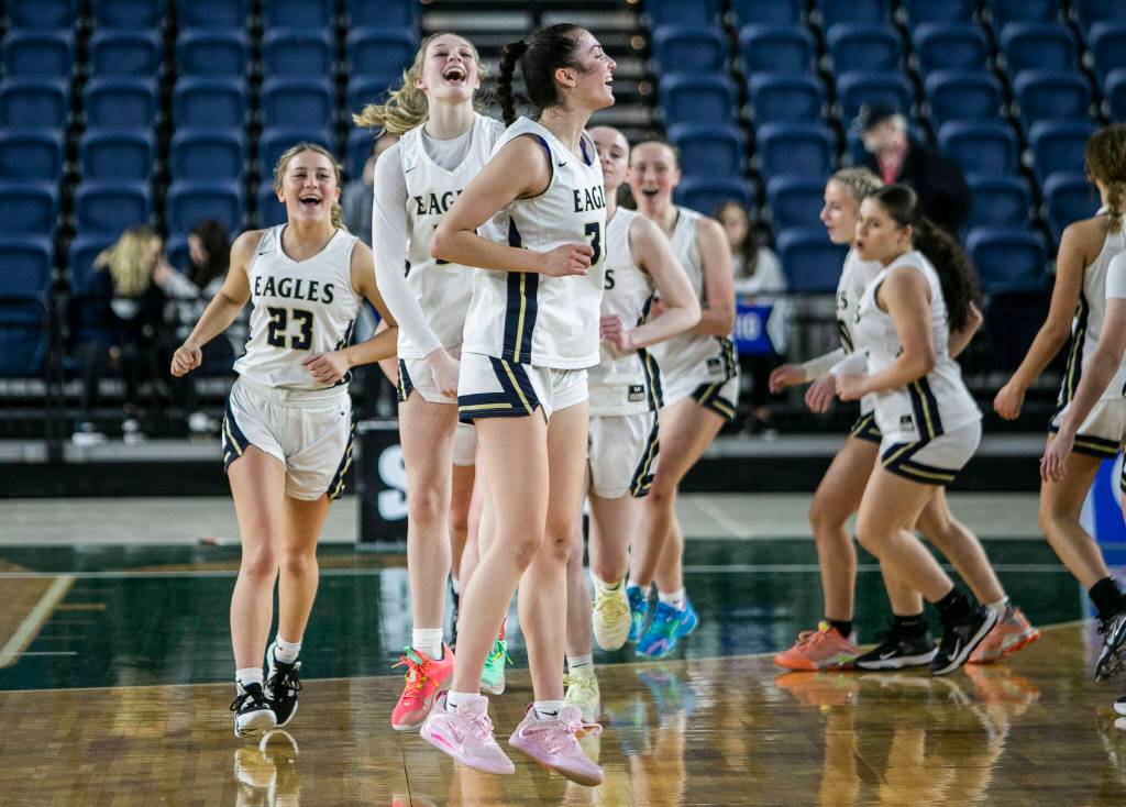 Arlington reacts to beating Meadowdale to advance to the 3A semifinals on Thursday, March 2, 2023 in Tacoma, Washington. (Olivia Vanni / The Herald)