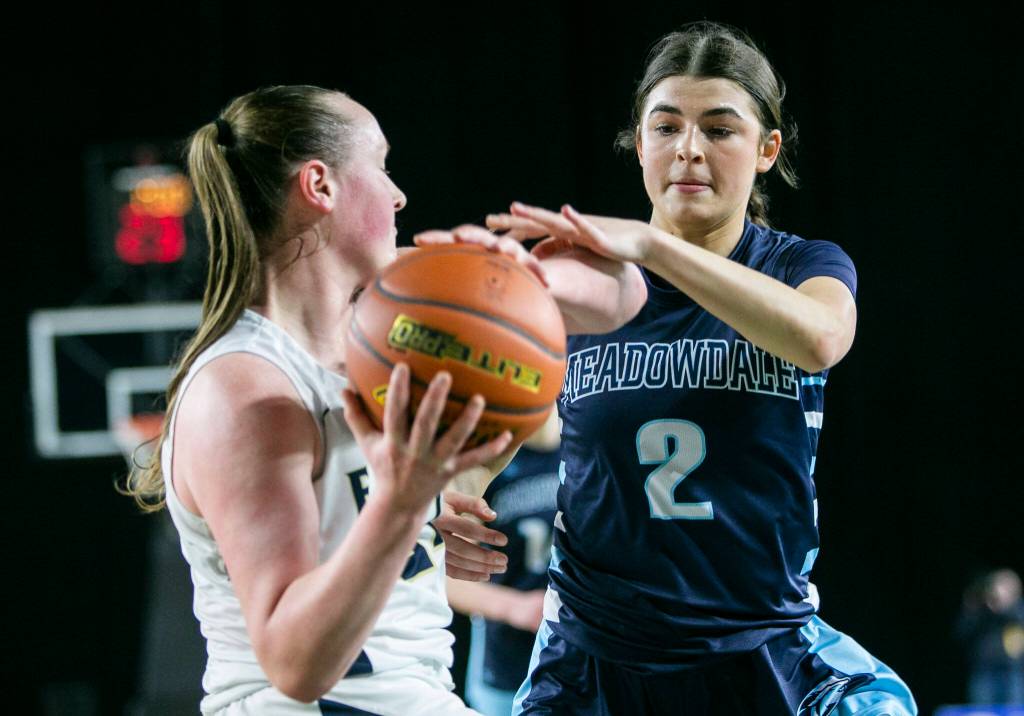 Meadowdales Gia Powel tries to steal the ball from Arlingtons Katie Snow during the 3A quarterfinal game on Thursday, March 2, 2023 in Tacoma, Washington. (Olivia Vanni / The Herald)