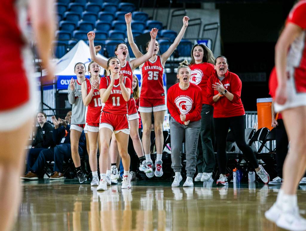 The Stanwood bench reacts to a three-point shot during the 3A quarterfinal game against Mead on Thursday, March 2, 2023 in Tacoma, Washington. (Olivia Vanni / The Herald)
