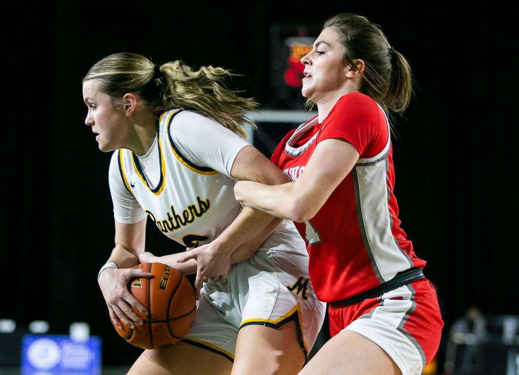 Stanwoods Tatum Brager grabs Meads Isabel Sterner while trying to get the ball during the 3A quarterfinal game against Mead on Thursday, March 2, 2023 in Tacoma, Washington. (Olivia Vanni / The Herald)