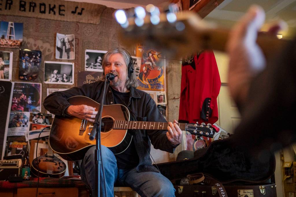 Dennis Coile also known as Dan Canyon sings and plays guitar during a Dan Canyon Band rehearsal in the groups practice barn in Arlington, Washington, on Saturday, March 11, 2023. (Annie Barker / The Herald)