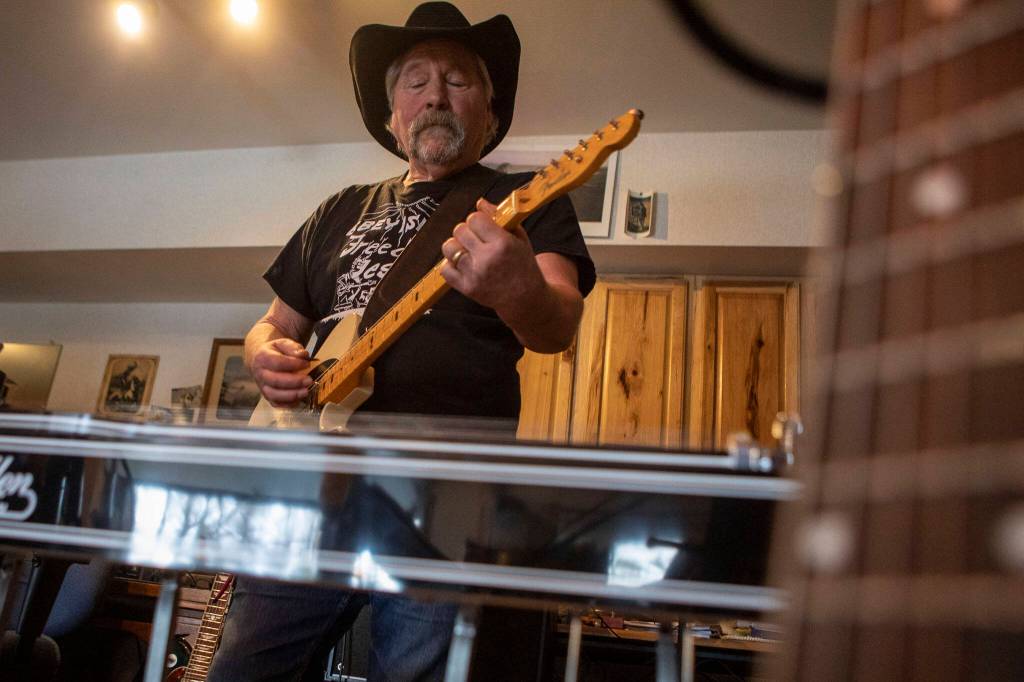 Pete Frothingham plays the guitar during a Dan Canyon Band rehearsal in their practice barn Saturday, March 11, 2023, in Arlington, Washington. (Annie Barker / The Herald)