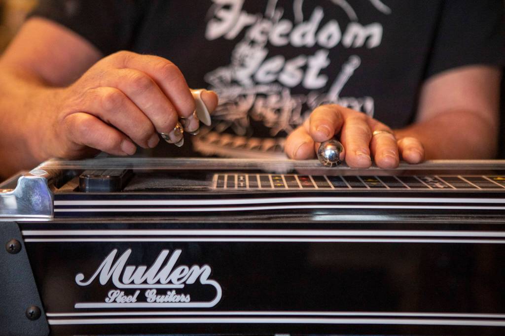 Pete Frothingham plays the pedal steel guitar during a Dan Canyon Band rehearsal in the groups practice barn in Arlington, Washington, on Saturday, March 11, 2023. (Annie Barker / The Herald)