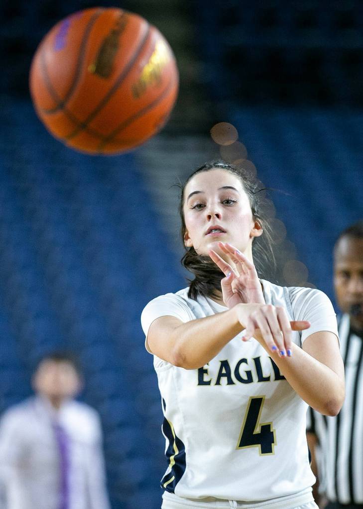 Arlingtons Maddy Fischer passes to the corner while playing against Lake Washington in the 3A semifinal on Friday, March 3, 2023, at the Tacoma Dome in Tacoma, Washington. (Ryan Berry / The Herald)
