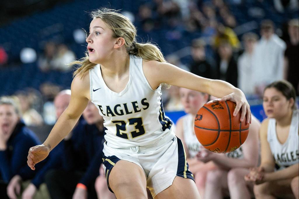 Arlingtons Jersey Walker takes the ball and looks to pass against Lake Washington in the 3A semifinal on Friday, March 3, 2023, at the Tacoma Dome in Tacoma, Washington. (Ryan Berry / The Herald)