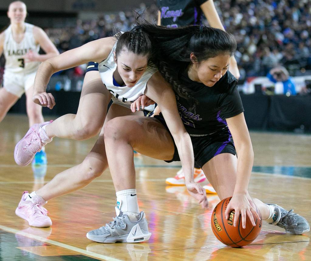 Arlingtons Jenna Villa loses the ball to the defense against Lake Washington in the 3A semifinal on Friday, March 3, 2023, at the Tacoma Dome in Tacoma, Washington. (Ryan Berry / The Herald)