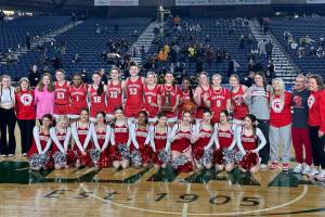 The Stanwood High School girls basketball team poses with their fourth-place trophy after beating Lincoln (Tacoma), 52-45, in the Class 3A Hardwood Classic on Saturday, March 4, 2023, at the Tacoma Dome in Tacoma, Washington. (Photo courtesy of Stanwood High School)