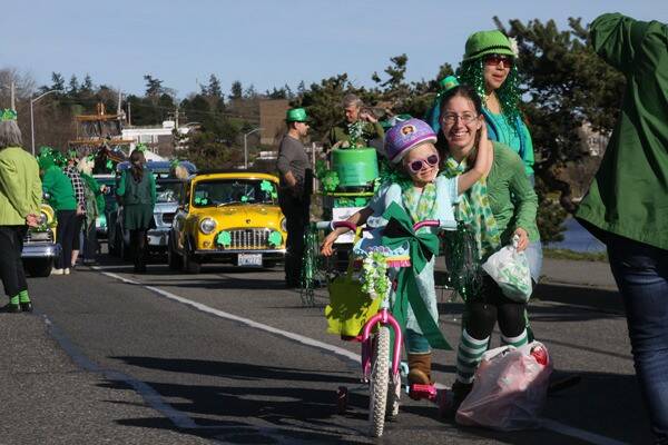 People clad in green pose for photos during a past St. Patricks Day parade in Oak Harbor. (Whidbey News-Times, file)