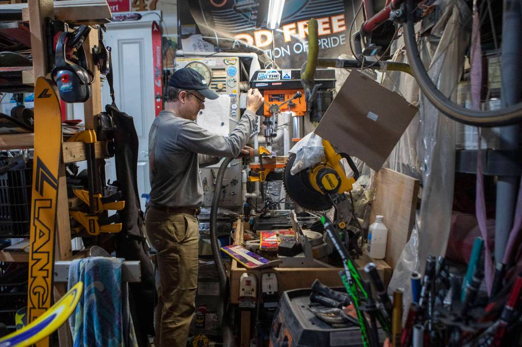 Brian Geppert at work in the workshop in his Lynnwood home. (Annie Barker / The Herald)