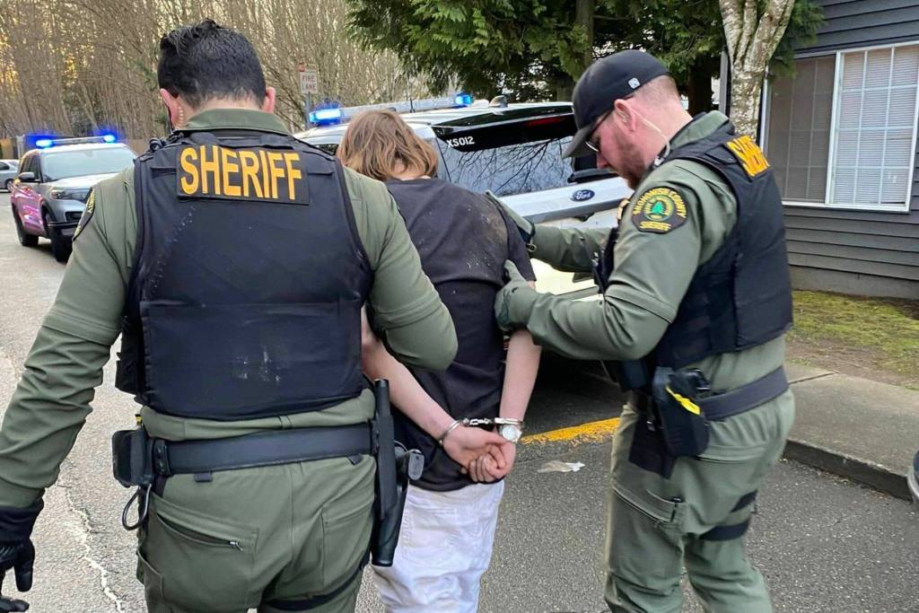 The 20-year-old male suspect (center) that crashed a truck into Carrolls Creek Landing on Monday, March 6, 2023, in Marysville, Washington. The suspect is in custody with minor injuries from a dog bite. (Snohomish Country Sheriffs Office)
