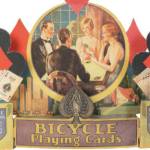 When advertisements include pictures of people, their clothing and hairstyles can help date the item. This store display for Bicycle Playing Cards is from about 1930.