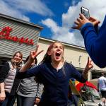 Mark Mulligan / The Herald
Ten-year-old Chloe Charles (center) jumps into the middle of a picture being taken by thirteen-year-old Jada Summers of the girls' respective mothers, Renee Charles (left) and Debbie Summers, outside of the new Chick-Fil-A location in Lynnwood Wednesday afternoon. The families showed up early Wednesday morning to be part of the first 100 people in line at the new location. The first one hundred people who camp overnight at the new location are entitled to one Chick-Fil-A combo meal a week for the next year. The Charles and Summers families met at the opening for the Bellevue Chick-Fil-A and were enjoying the family atmosphere. Games throughout the day keep the families occupied.
Photo taken 20150506