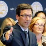 Washington Attorney General Bob Ferguson, center, talks to reporters, Monday, Aug. 26, 2019. (AP Photo/Ted S. Warren)