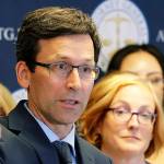 Washington Attorney General Bob Ferguson, center, talks to reporters, Monday, Aug. 26, 2019. (AP Photo/Ted S. Warren)