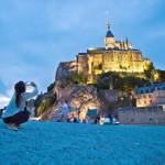 Christian pilgrims and tourists are drawn to the dramatically situated Mont St-Michel, a soaring island abbey in Normandy that is completely surrounded by the sea at high tide.