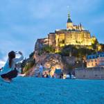 Christian pilgrims and tourists are drawn to the dramatically situated Mont St-Michel, a soaring island abbey in Normandy that is completely surrounded by the sea at high tide.