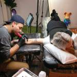 Hurtado works on a new tattoo for returning client Cheyenne Stultz. (Ryan Berry / The Herald)