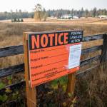 A notice, seen here Oct. 13, 2022, at the site of the proposed mental health facility at 300th Street NW and 80th Avenue NW north of Stanwood. (Olivia Vanni / Herald file)