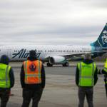 Airport workers watch as an Alaska Airlines Boeing 737 embarks on the first 737 flight out of Paine Field Airport Thursday, Feb. 17, 2022, in Everett, Washington. (Ryan Berry / The Herald)