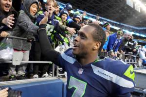 Seattle Seahawks quarterback Geno Smith (7) celebrates with fans after an NFL football game against the New York Jets , Sunday, Jan. 1, 2023, in Seattle. The Seahawks defeated the Jets 23-6. (AP Photo/Ted S. Warren)
