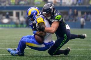 Los Angeles Rams running back Cam Akers (3) is tackled by Seattle Seahawks linebacker Cody Barton (57) during the first half of an NFL football game Sunday, Jan. 8, 2023, in Seattle. (AP Photo/Abbie Parr)