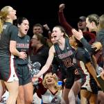 Washington State celebrates a 3-point basket by guard Charlisse Leger-Walker, second from left, during the second half of an NCAA college basketball game against UCLA in the finals of the Pac-12 women's tournament Sunday, March 5, 2023, in Las Vegas. (AP Photo/David Becker)