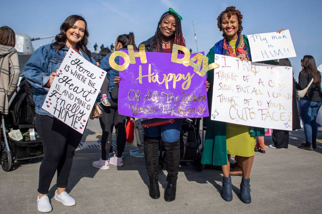 Left to right, Tyler Morgan, Martina Allen, and Kelicia Jessie wait for their loved ones to arrive in Everett, Washington on Friday, March 17, 2023. The USS Barry arrived to its new homeport at Everett Naval Station, previously from Yokosuka, Japan. The crew is led by Commanding Officer, Cmdr. Grant Bryan. (Annie Barker / The Herald)