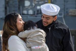 Left to right, Saharah Mendoza, Cielo Mendoza and Octavio Mendoza, reunite in Everett, Washington on Friday, March 17, 2023. The USS Barry arrived to its new homeport at Everett Naval Station, previously from Yokosuka, Japan. The crew is led by Commanding Officer, Cmdr. Grant Bryan. (Annie Barker / The Herald)