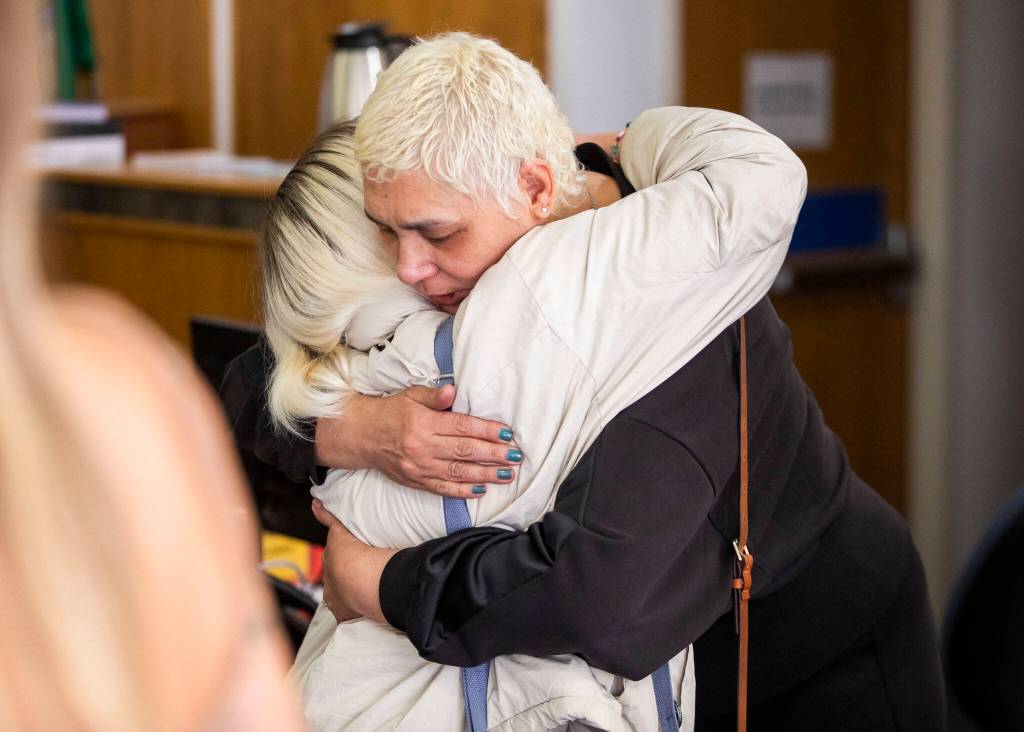 Xochitl Hofland, the mother of victim Andre Hofland, hugs a friend Wednesday after Dominic Wilsons sentencing at the Snohomish County Courthouse in Everett. (Olivia Vanni / The Herald)