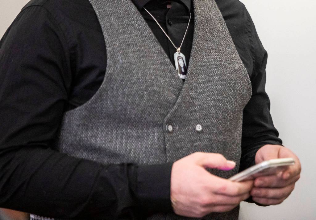 A friend of Andre Hofland wears a necklace with his photograph Wednesday as he addresses the court at the Snohomish County Courthouse in Everett. (Olivia Vanni / The Herald)