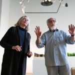 Guest curators Meg Holgate and Steve Klein discuss the positioning of a piece on the gallery wall during the installation of A Precarious Edge at Schack Art Center on Sunday, March 19, 2023, in Everett, Washington. The two Washington artists are featuring their environment-oriented work on the main floor and curating an exhibit called Exploring The Edge on the mezzanine gallery that features nine other area artists. (Ryan Berry / The Herald)