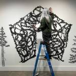Artist Ann Chadwick Reid puts the finishing touches on a delicate piece called Solastalgia during the setup for Exploring The Edge at Schack Art Center on Sunday, March 19, 2023, in Everett, Washington. (Ryan Berry / The Herald)