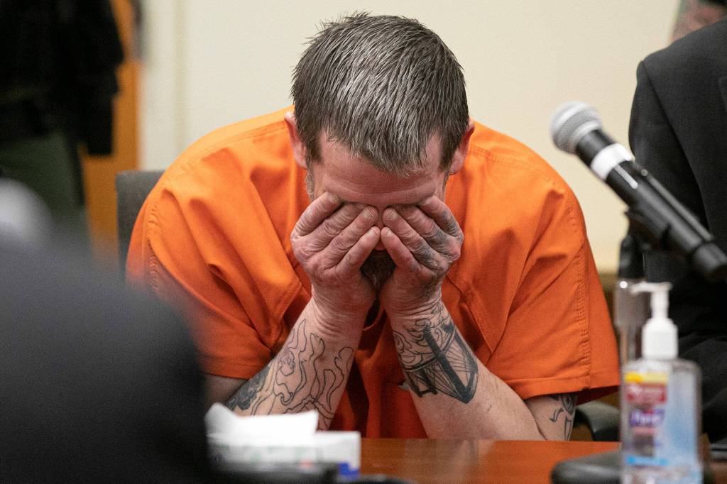 Richard Rotter puts his head in his hands after entering a not-guilty plea on all three charges against him on April 25, 2022, at Snohomish County Superior Court in Everett, Washington. Rotter has been charged with the murder of Everett Police Officer Dan Rocha. (Ryan Berry / The Herald)