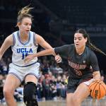 Washington State guard Charlisse Leger-Walker (right) dribbles past UCLAs Emily Bessoir during the finals of the Pac-12 womens tournament on March 5 in Las Vegas. (AP Photo/David Becker)