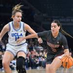 Washington State guard Charlisse Leger-Walker handles the ball against UCLA forward Emily Bessoir during the first half of an NCAA college basketball game in the finals of the Pac-12 women's tournament, Sunday, March 5, 2023, in Las Vegas. (AP Photo/David Becker)