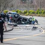 Police walk around the scene of a car crash along Ingraham Boulevard on Friday, March 17, 2023, in Marysville. (Olivia Vanni / The Herald).