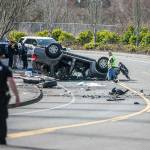 Police walk around the scene of a car crash along Ingraham Boulevard on Friday, March 17, 2023 in Marysville, Washington. (Olivia Vanni / The Herald).