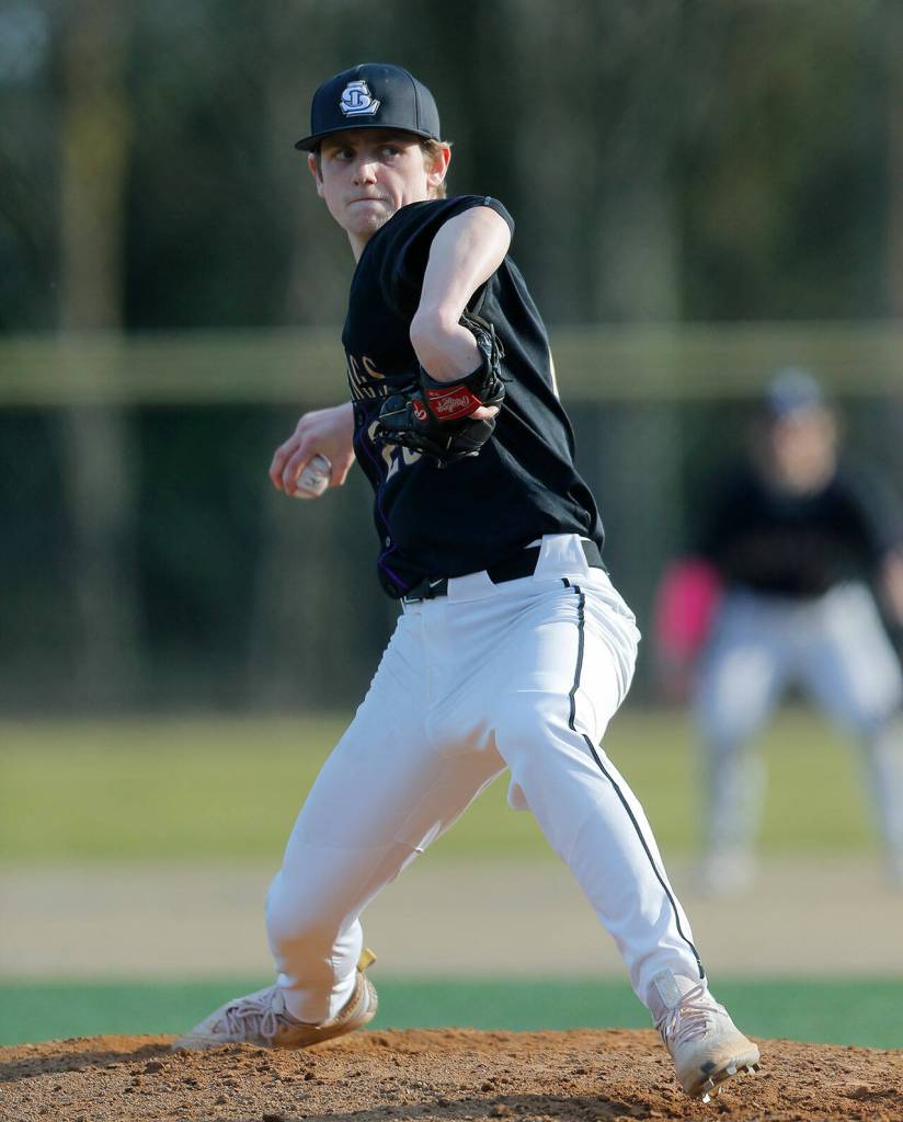 Lake Stevens starter Kaiden Sekely winds up to pitch during a game against Lynnwood on Friday, March 17, 2023, at Lake Stevens High School in Lake Stevens, Washington. (Ryan Berry / The Herald)